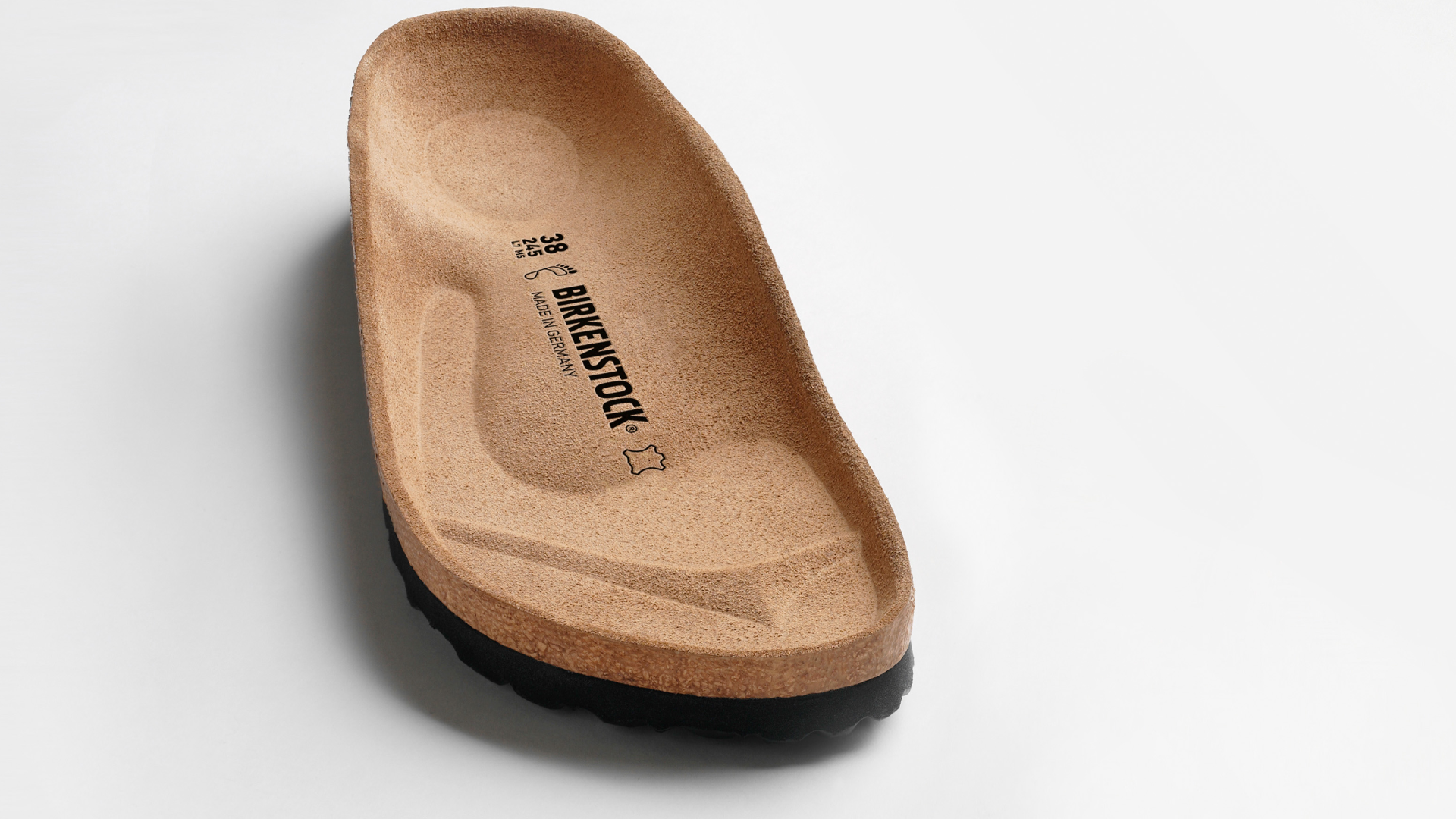 Plantare originale Birkenstock con sottopiede in pelle scamosciata su sfondo bianco.