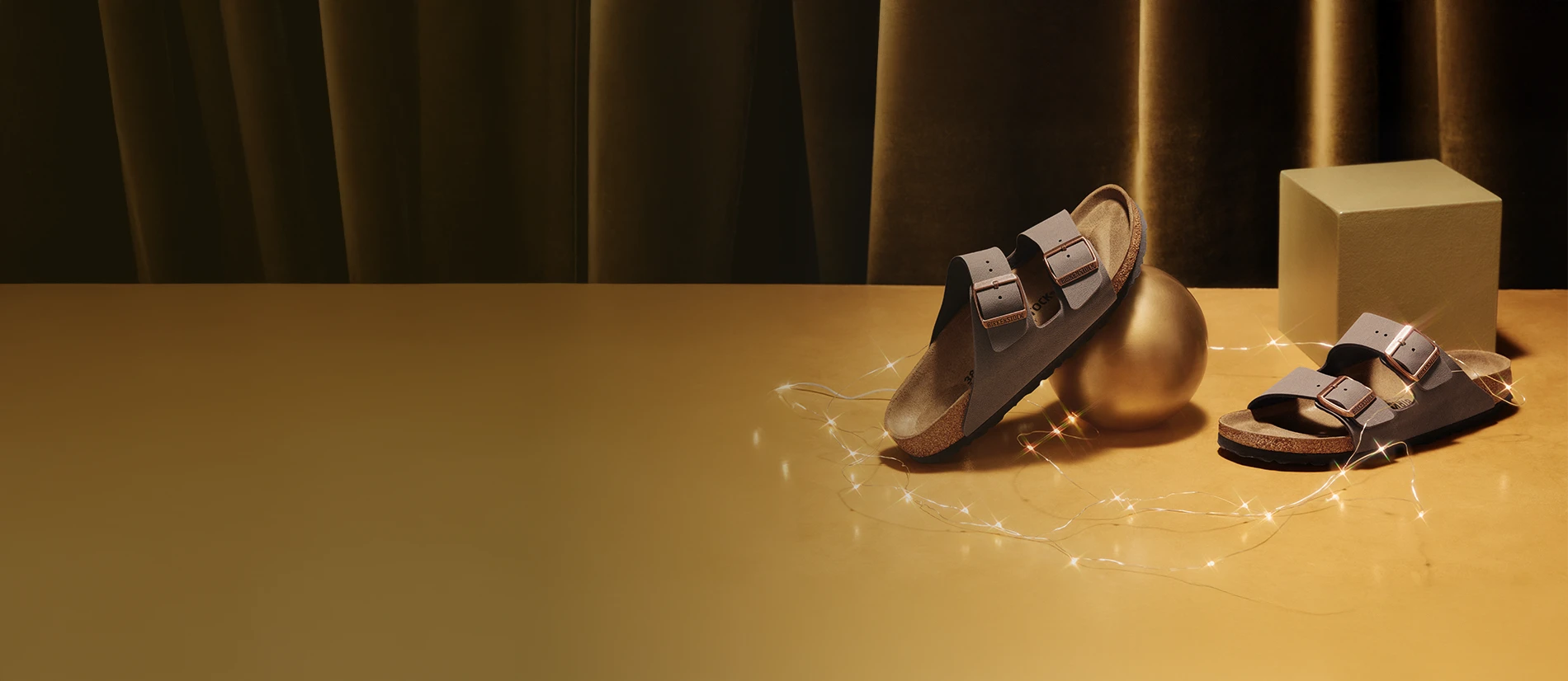 Primo piano di arizona birkenstock mocca su pavimento dorato con luci natalizie